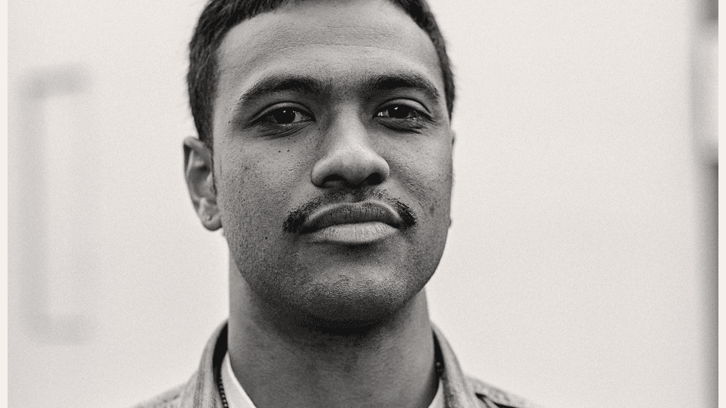 Close up of a young Black man with a moustache