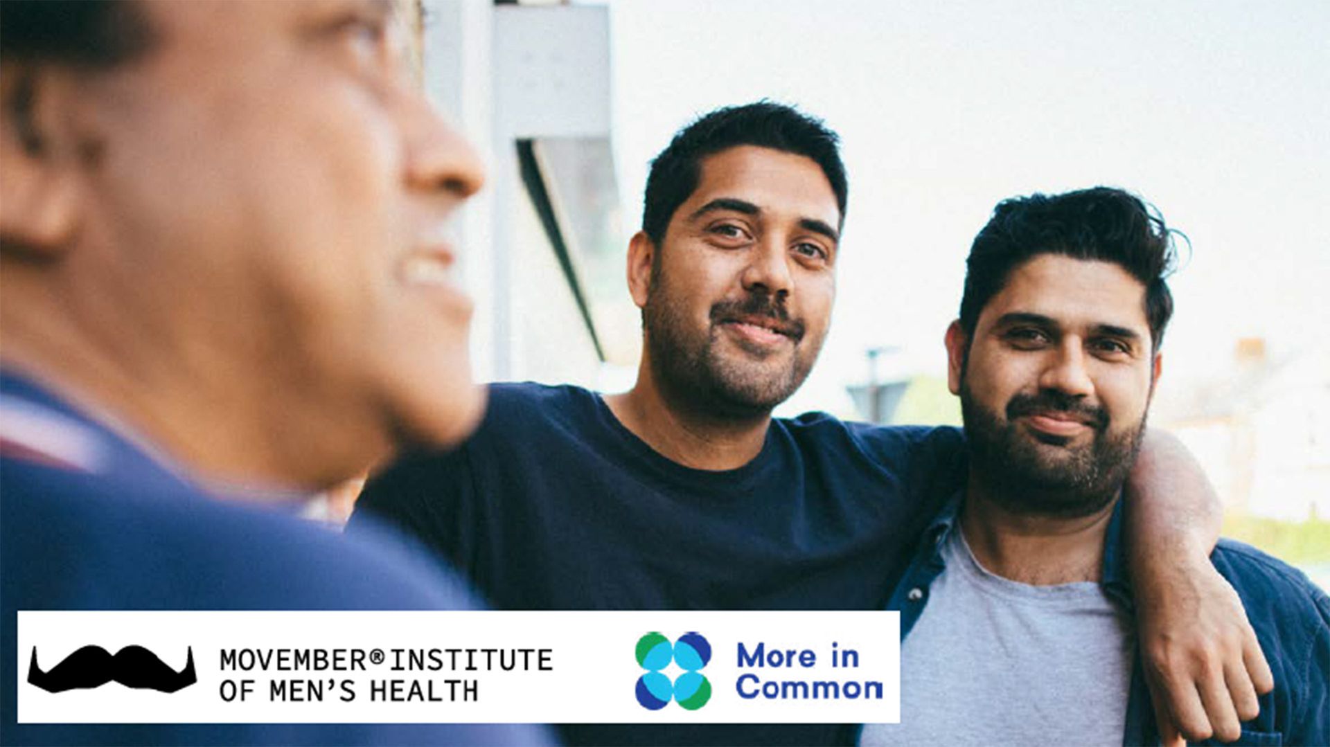 Photo of jovial-looking men posing to camera.