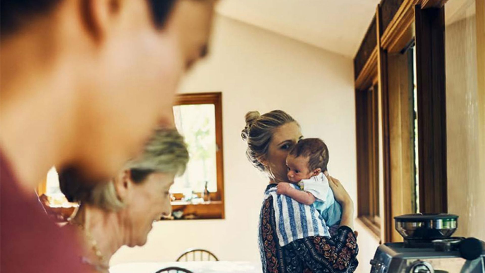 Photo of busy people in a family kitchen.