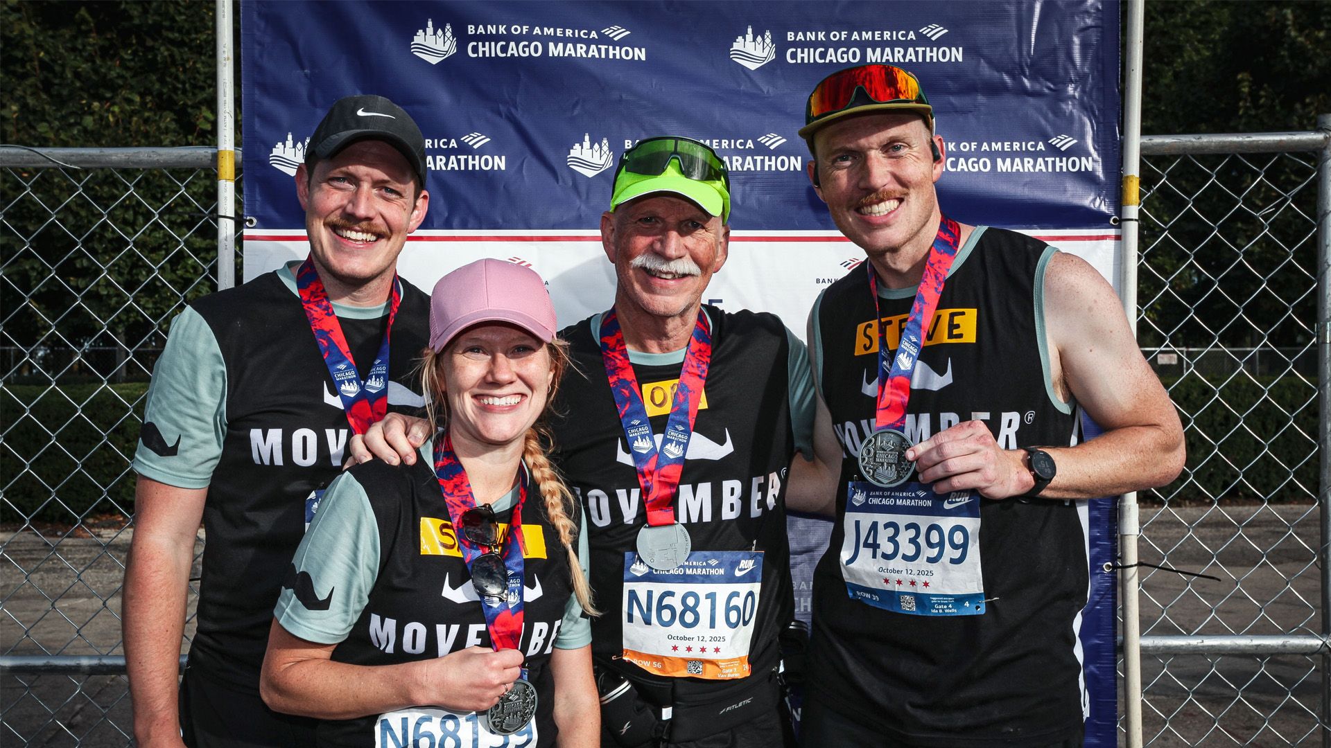 Group of Chicago Marathon runners showing off their medals