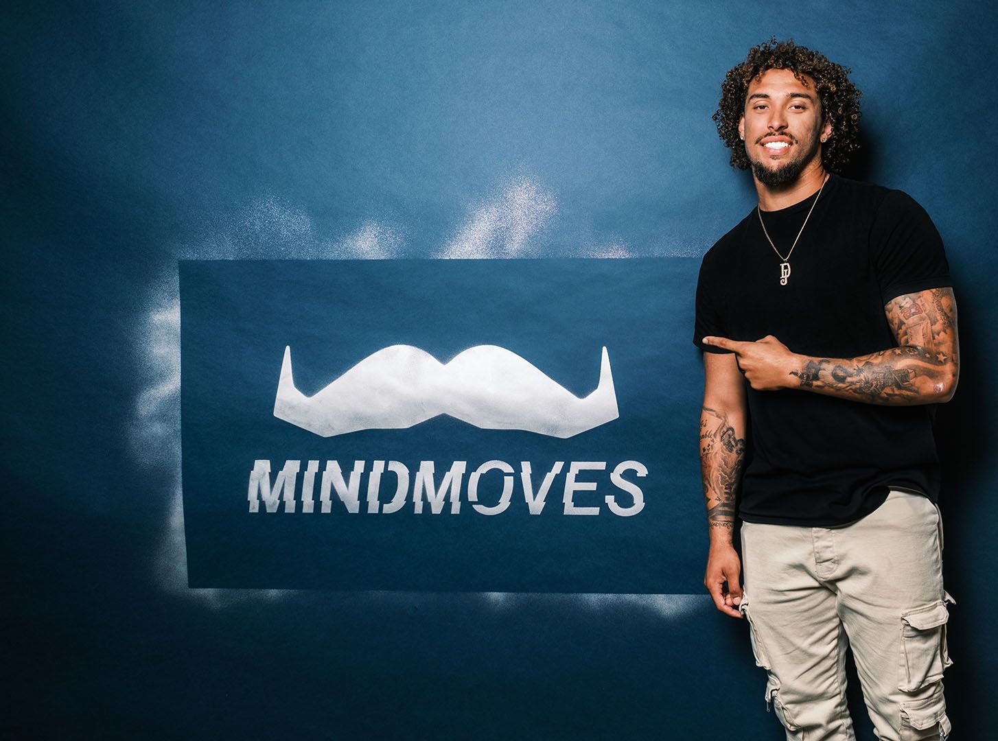 Photo of an athlete standing before a Mind Moves sign.