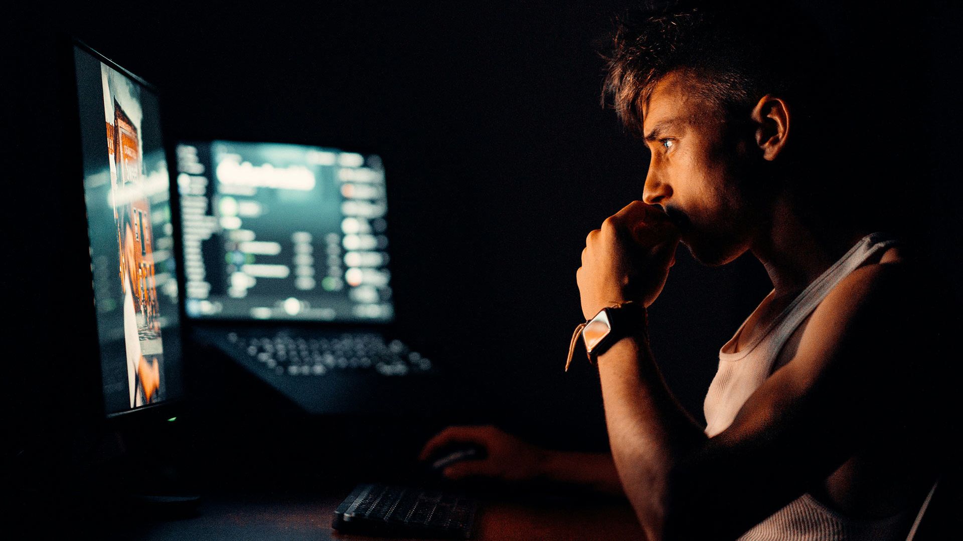 Stock photo of a young man in front a computer
