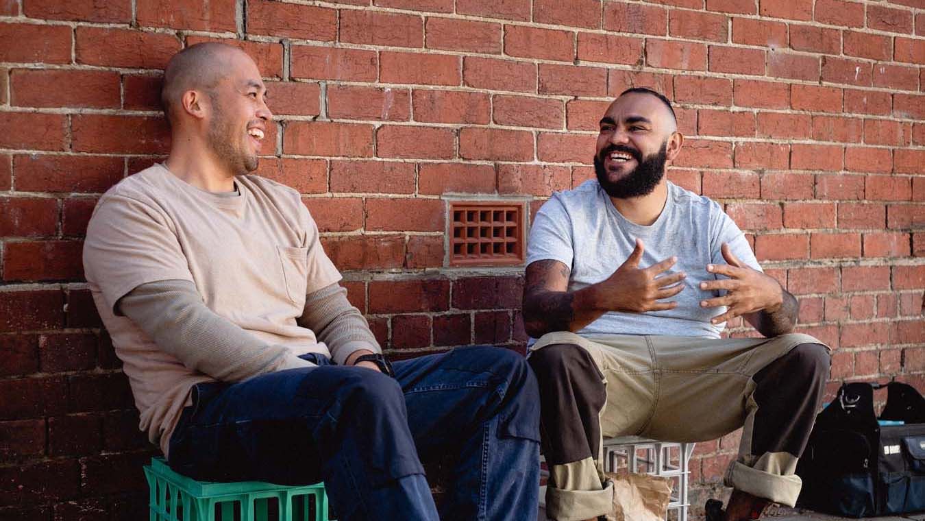 Two men chatting together on a work break.