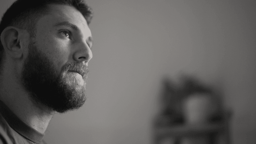 Close-up of young man with beard gazing into the distance