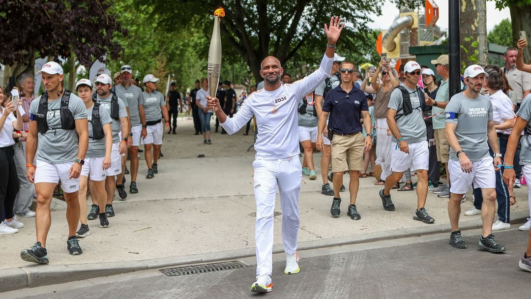 Anil carrying the Olympic torch in Sen, france