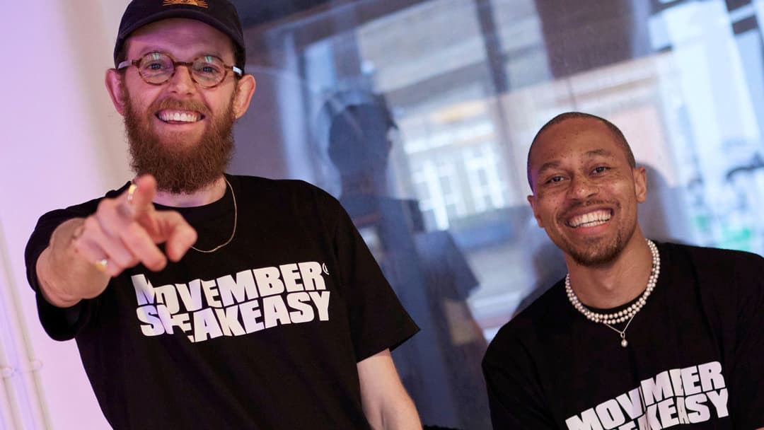 Photo of two young men wearing Movember SpeakEasy t-shirts.