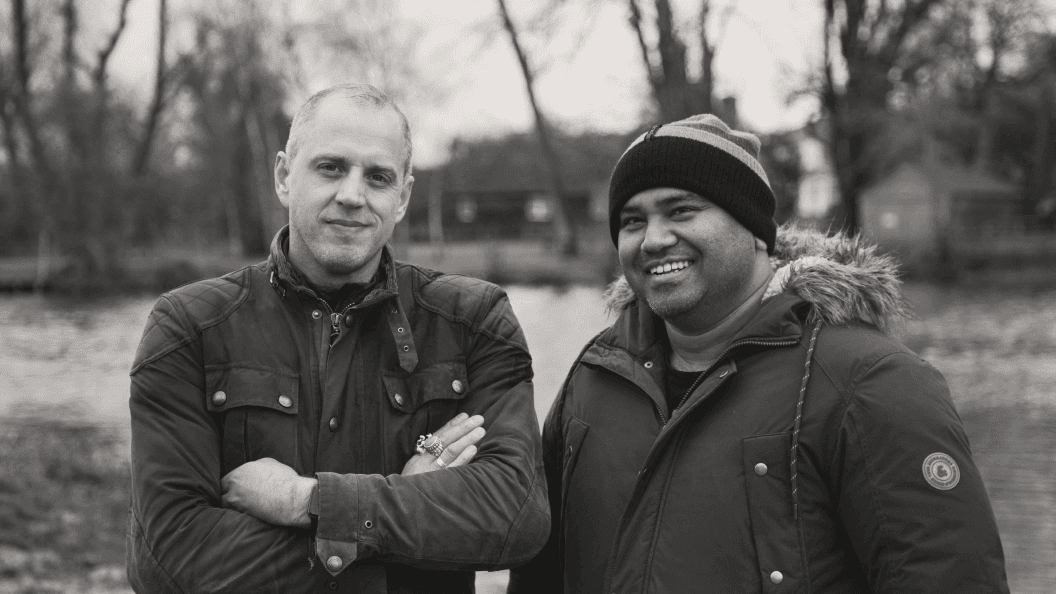 Photo of two men smiling to camera.