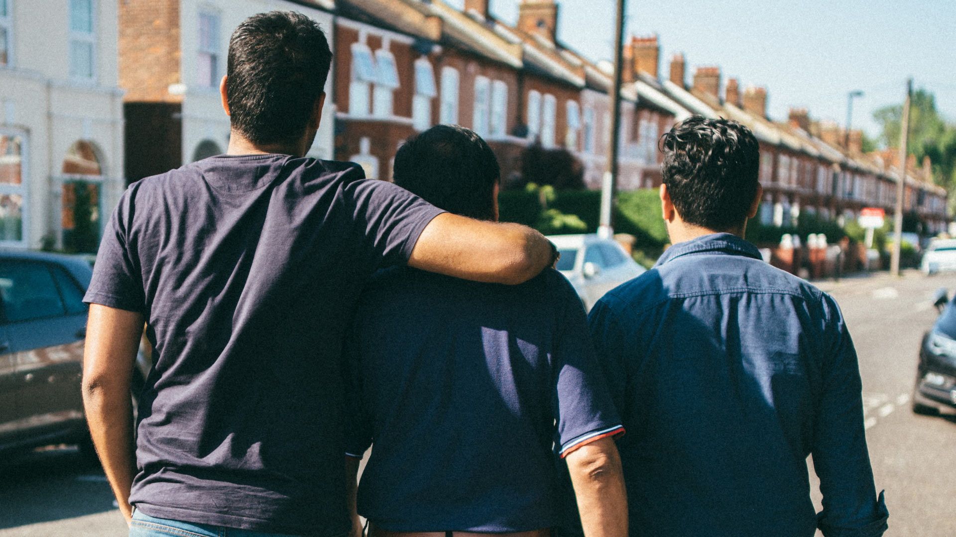 Photo of several friends hanging out on a street.